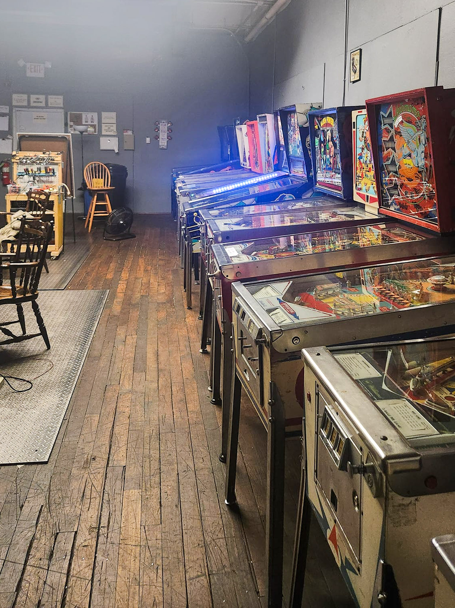 Rows of lit pinball games inside the club space